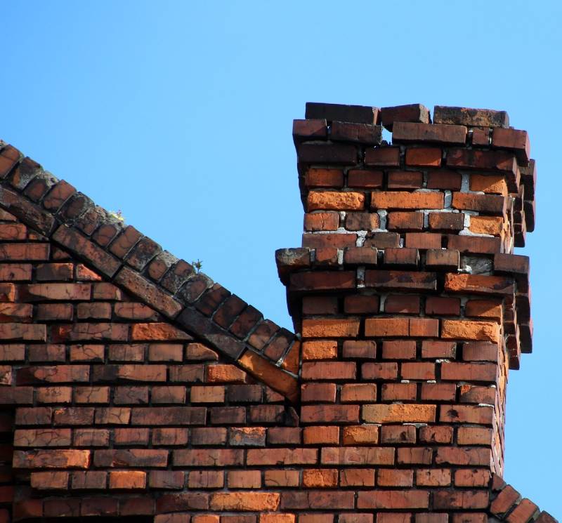 Damaged chimney on an Lawndale home showing cracks and missing mortar
